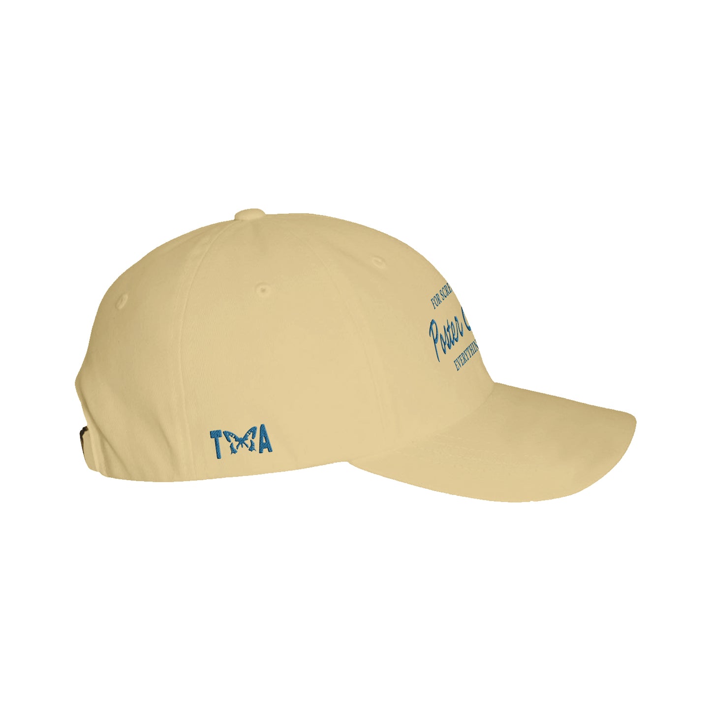 A beige Taylor Acorn Butter Dad Hat with blue "TMA" text on the side, featuring a butterfly inside the "A". Blue embroidered text appears partially visible on the front.