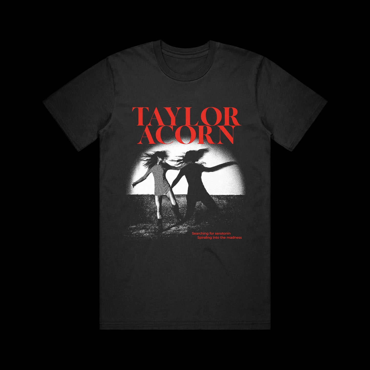Black Comfort Colors t-shirt by Taylor Acorn with bold red TAYLOR ACORN above a black-and-white photo of two women running. Below, red text reads: Searching for Serotonin, Something Has the Shadows.