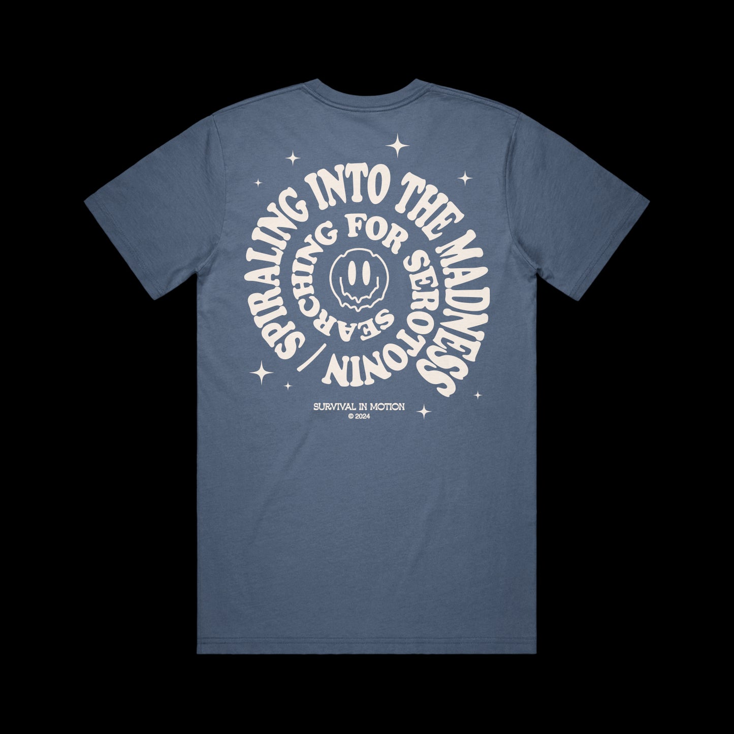 Taylor Acorn Blue Comfort Colors t-shirt with white SPIRALING INTO THE MADNESS, SEARCHING FOR SERIOUS STARS around a smiling face and stars on the back. SURVIVAL IN MOTION ©2024 printed at the bottom.