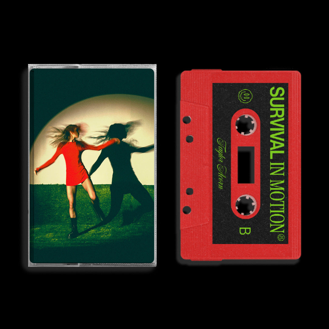 A red cassette tape labeled Survival In Motion by Taylor Acorn rests beside its case, which shows a figure in a red dress running across a circle of light—plus tease of a MYSTERY BONUS TRACK.