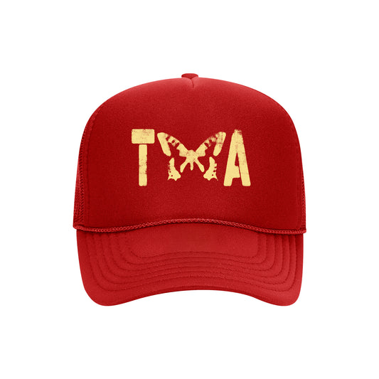 A red Taylor Acorn Otto Cap trucker hat with TWA in distressed yellow font—the W formed by a butterfly design. Ideal for fans of printed Trucker Hats.