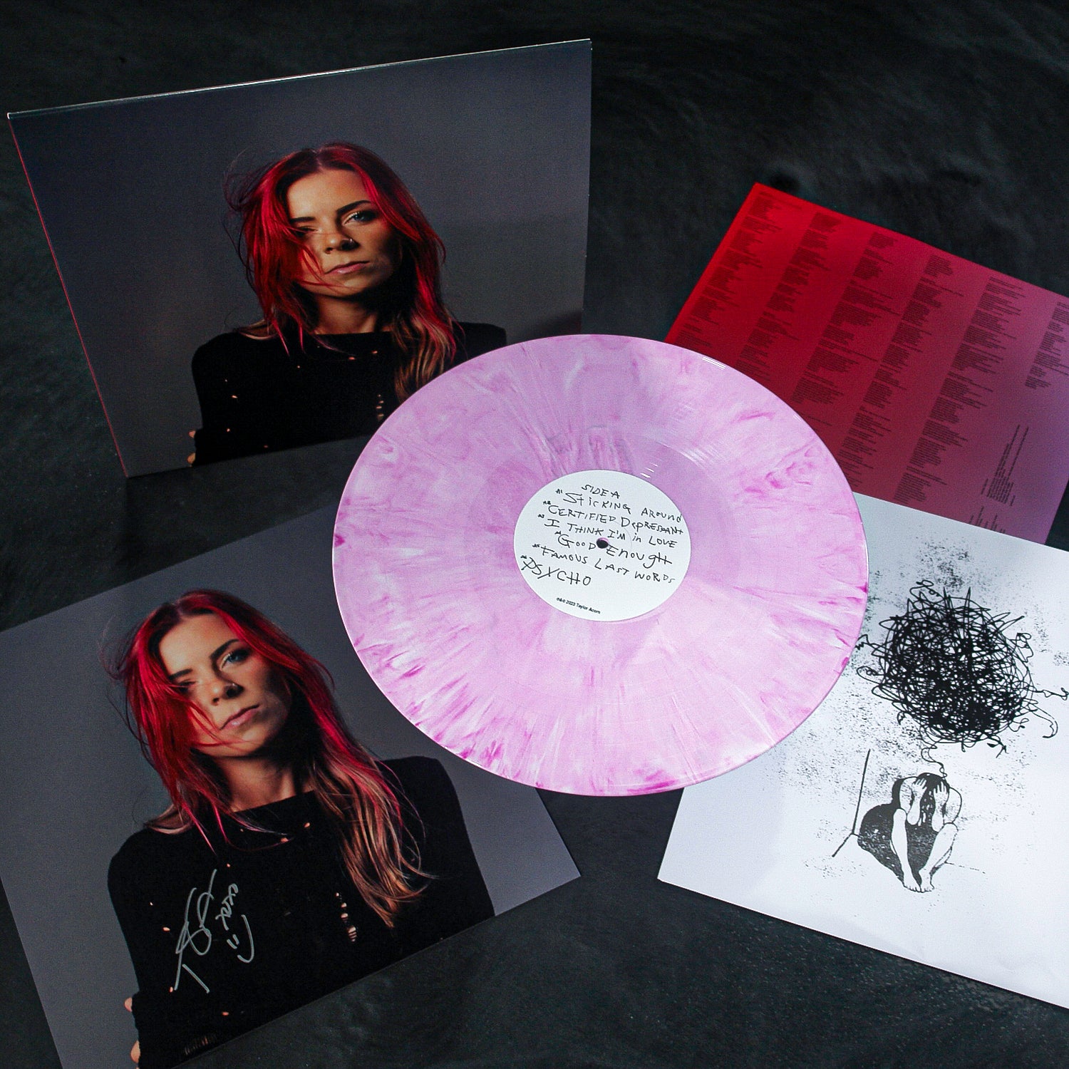 A pink and white marbled Signed vinyl by Taylor Acorn is shown with album art featuring a red-haired woman, handwritten notes, lyrics, an abstract black-and-white drawing, and exclusive Certified Depressant bonus tracks.