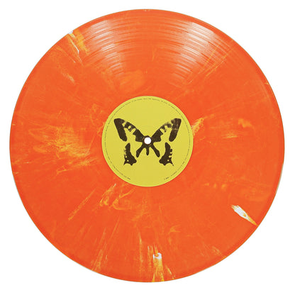 An orange vinyl record with yellow marbling and a yellow center label featuring a black butterfly design, by Taylor Acorn, housed in a gatefold jacket.