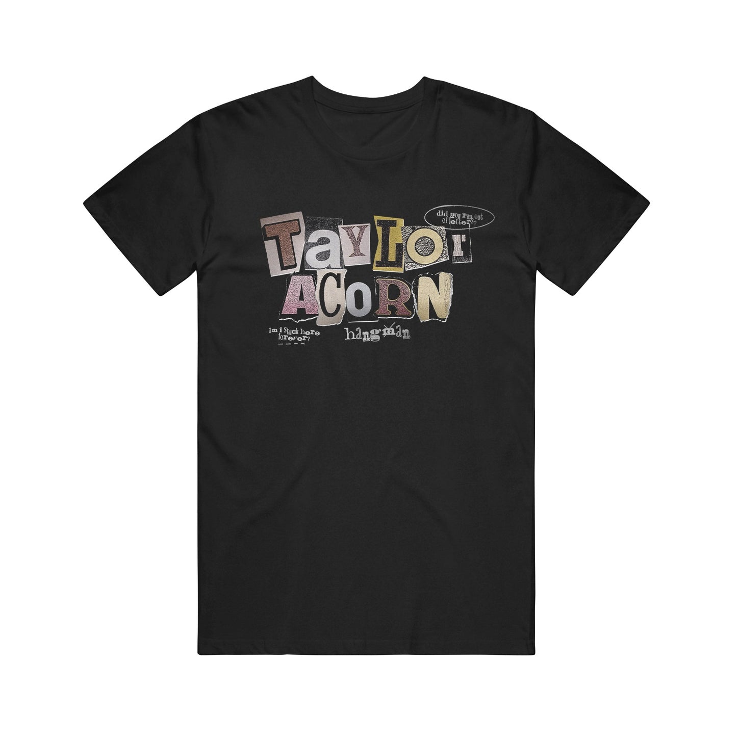 A black Taylor Acorn Comfort Colors T-shirt features colorful, cut-out style letters spelling “Taylor Acorn” and smaller text underneath, creating a distinctive ransom note aesthetic.