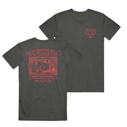 Black Comfort Colors t-shirt by Taylor Acorn featuring red text and graphics. Small Taylor Acorn logo on the front left chest; back displays bold Shapeshifting text, a curled-up figure, and additional Taylor Acorn branding.